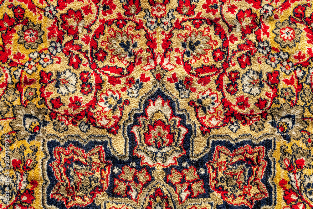 Fragment of an old shabby colored carpet