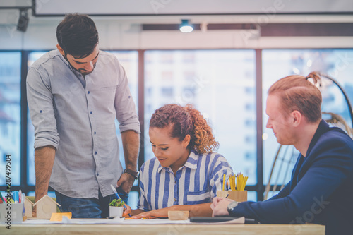 Team of young Business starter is brainstroming in a co working space photo