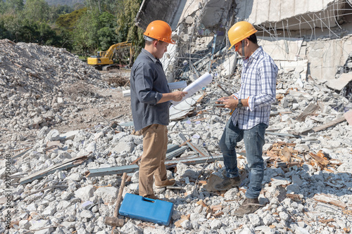 Engineer architect and worker operation control demolish old building.