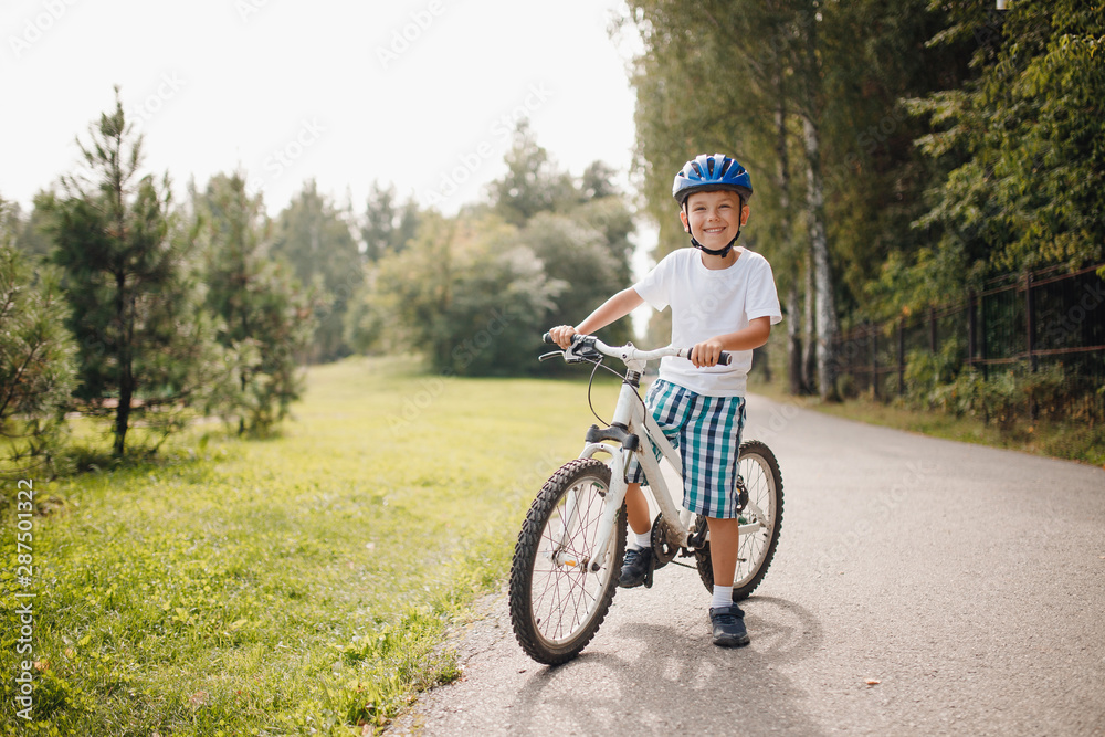 Little boy in helmet learning to ride bicycle park having fun. Little boy in helmet learning to ride bicycle park having fun.