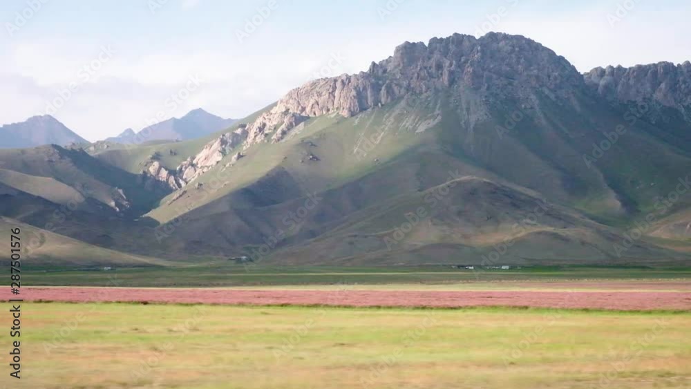 Driving through some of the most stunning roads in Kyrgyzstan. Silk road located in Kyrgyzstan and Tajikistan offers some breathtaking views over the snow-capped mountain range Driving through some of the most stunning roads in Kyrgyzstan. Silk road located in Kyrgyzstan and Tajikistan offers some breathtaking views over the snow-capped mountain range