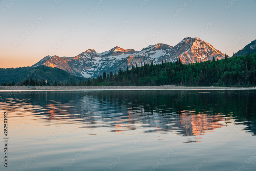 Fototapeta premium Mountains reflecting in Silver Lake Flat Reservoir at sunset, near the Alpine Loop Scenic Byway in American Fork Canyon, Uinta-Wasatch-Cache National Forest, Utah