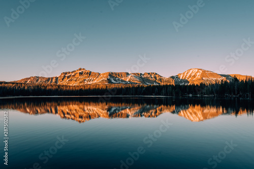 Tableau sur toile Snowy mountains reflecting in Mirror Lake, in the Uinta Mountains, Utah