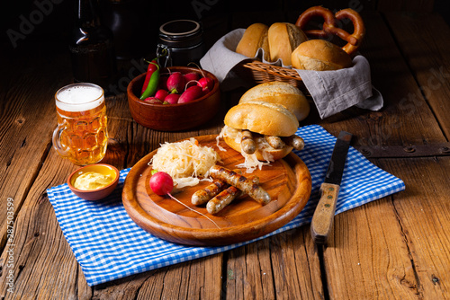 rustic Thuringian bratwurst with sauerkraut and roll photo