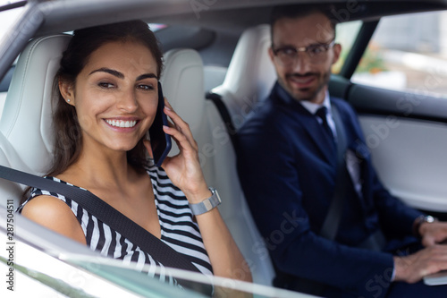 Wife speaking by phone while sitting near husband in car © zinkevych
