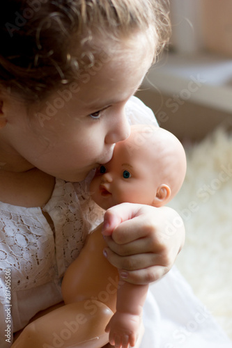 Little kid girl with the toy puppet or doll