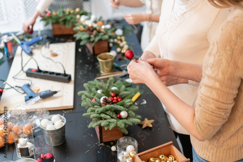 Christmas decor with their own hands. Woman created a xmas arrangement. Master class on making decorative ornaments. Flower shop