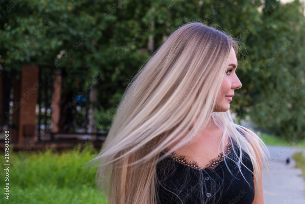Portrait of a young woman with long shiny blond hair. Hair care concept. Portrait of a young woman with long shiny blond hair. Hair care concept.