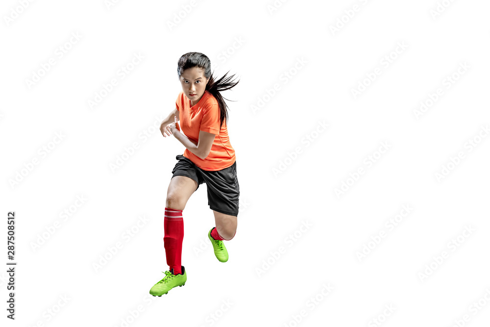 Asian football player woman in the pose of kicking the ball