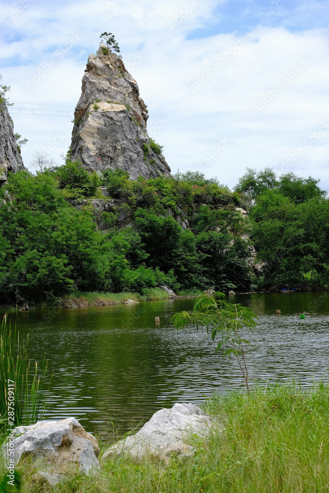 A sharpen rock mountain overlooking a swamp