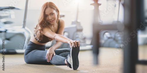 Beautiful Asian woman with tan and slim body stretching legs before exercise Free Download Beautiful Asian woman with tan and slim body stretching legs before exercise - GFXLoad