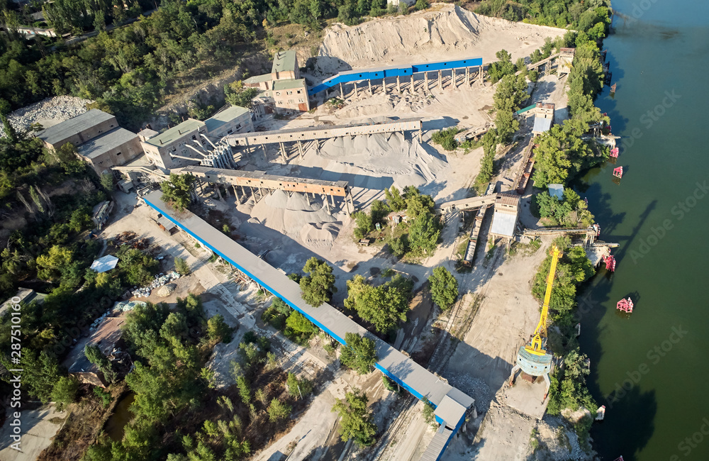 Aerial view of the processing plant with the sand fractionator at the edge of a quartz sand quarry pond for white quartz sand, made with drone