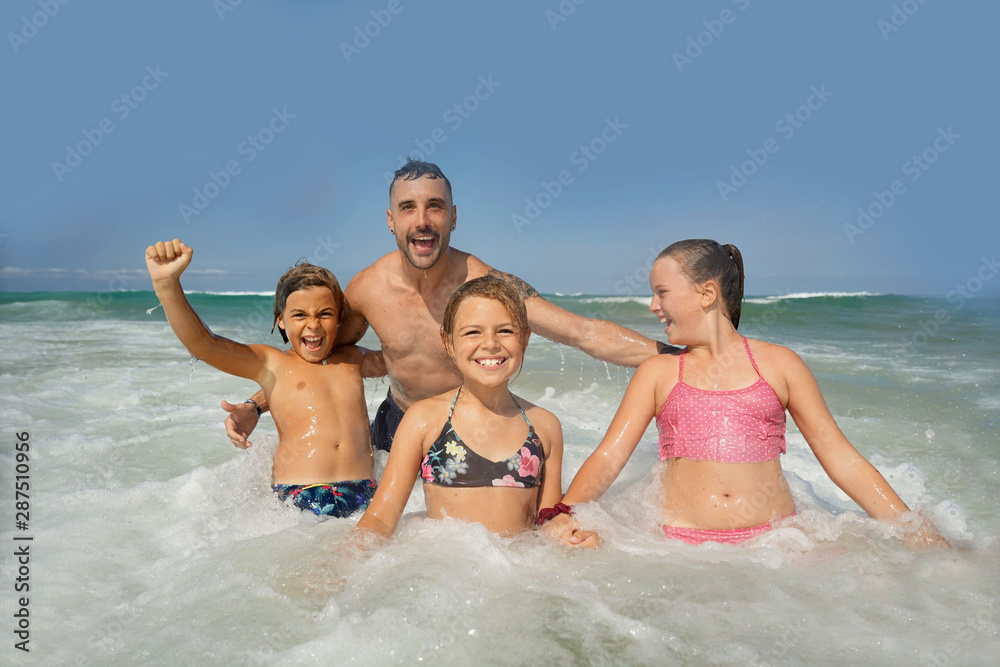 Family having fun in the waves Family having fun in the waves