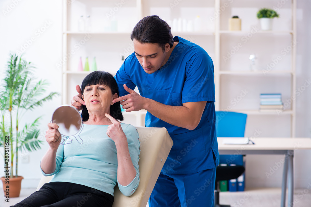 Old woman visiting male doctor for plastic surgery