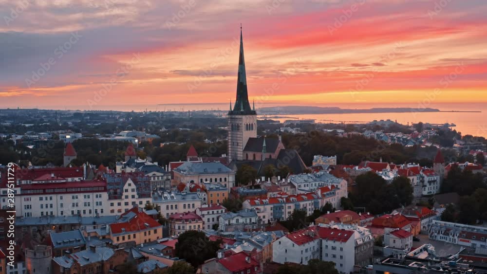 Tallinn, Estonia: epic drone view of St. Olaf's Church Tower and amazing sunset sky in old town