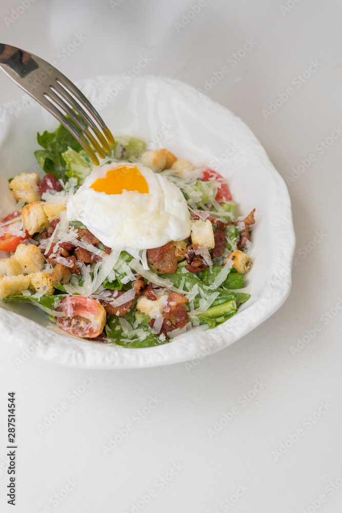 Cesar Salad with egg for breakfast in the restaurant. Cesar Salad with egg for breakfast in the restaurant.