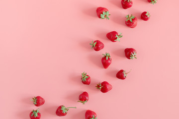 Strawberries on pink background. Strawberries berries pattern. Creative food concept. Flat lay, top view, copy space