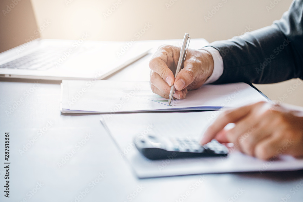Business man working at office with laptop and documents on his desk Business man working at office with laptop and documents on his desk
