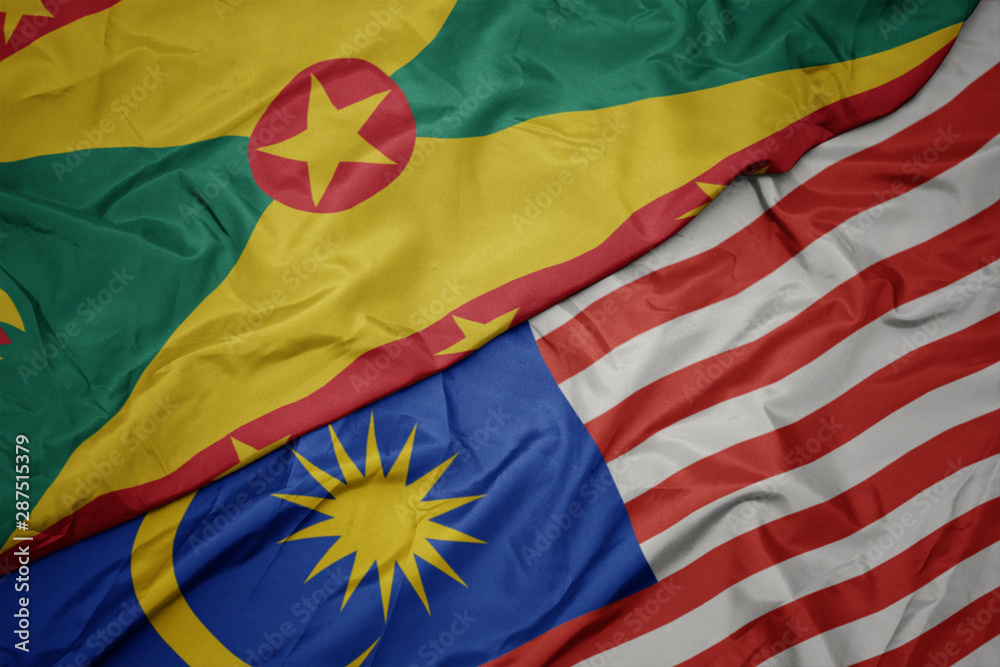waving colorful flag of malaysia and national flag of grenada.