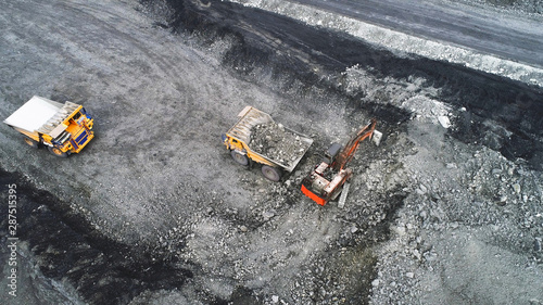 Coal mining in a quarry. A hydraulic excavator loads a dump truck.