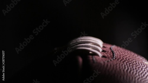 Darkened close up of American Football laces A
