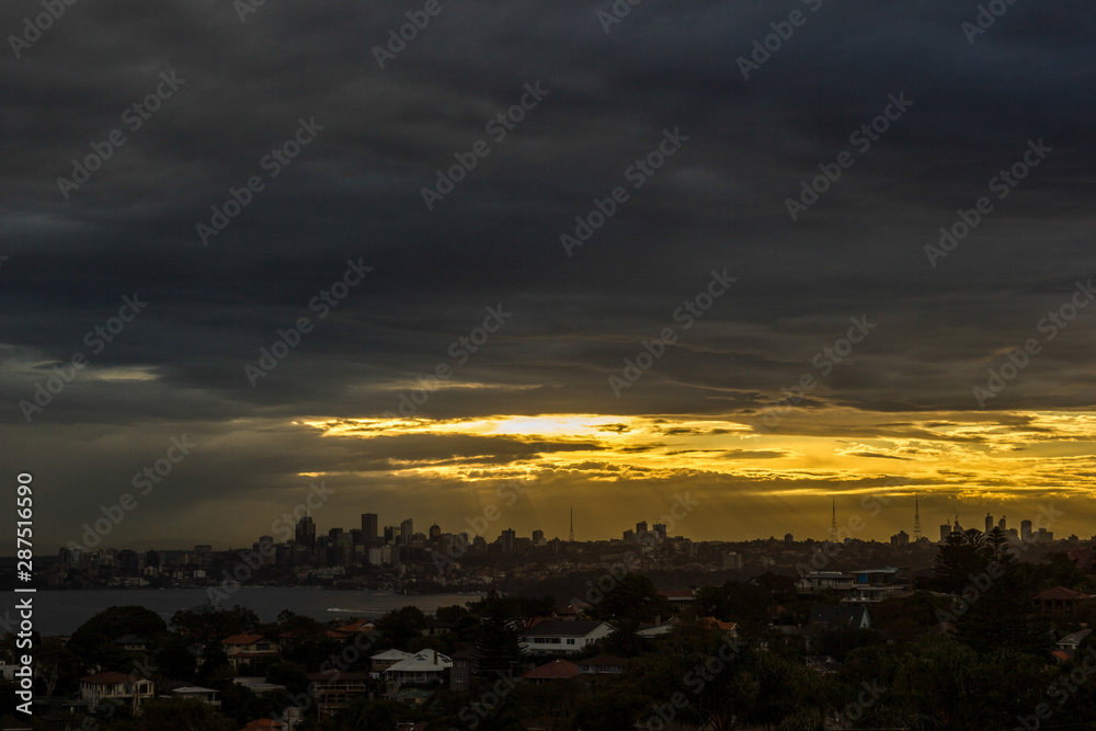 Sydney Panorama taken from a unique position at sunset, sunrays shining on the city