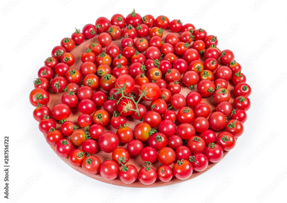 Cherry tomatoes on the wooden serving board on white background Cherry tomatoes on the wooden serving board on white background