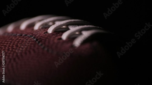 Darkened close up of American Football laces D