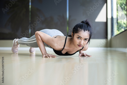 Women exercising by pushing the floor in the gym