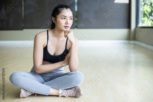 Women sitting wearing exercise clothes and chin on their hands