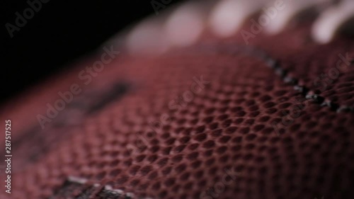 Darkened close up of American Football laces E