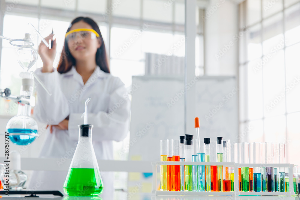 Positive delighted female scientist doing experiment Positive delighted female scientist doing experiment