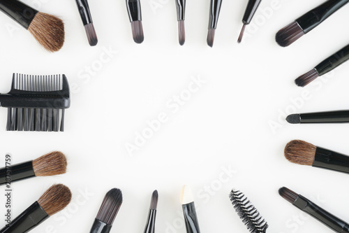 Brown brushes set up over white background. women make up concept. Flat lay, top view. Copy space.