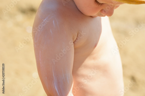 Caring for baby skin. Cream applied to the child   s hand