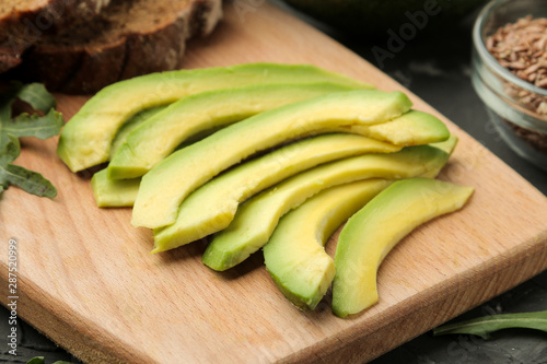Avocado, bread. ingredients for making avocado sandwiches. On a dark background.