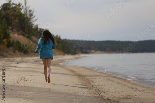 young woman running on the beach