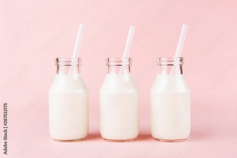 Three bottles of milk of yogurt on pink background. Three bottles of milk of yogurt on pink background.