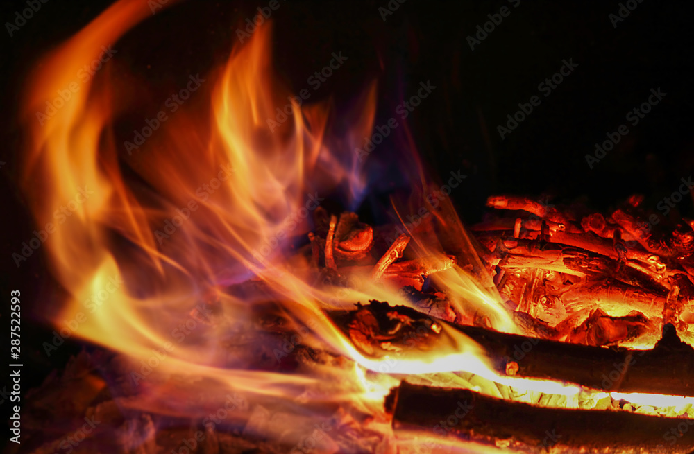 Fire, flame on a black background, burning embers, motion blur. Abstract background.