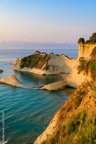 Cape Drastis at sunset close to Peroulades and Sidari village - Beautiful coast scenery with High cliffs and paradise beach - Corfu, Ionian island, Greece