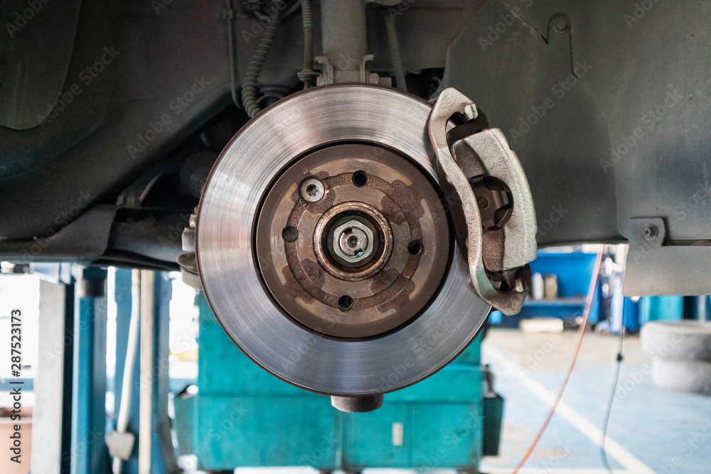 Close up disc brake at car service workshop