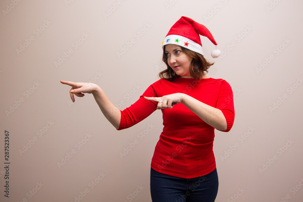 happy girl in santa hat in red blouse on white background happy girl in santa hat in red blouse on white background