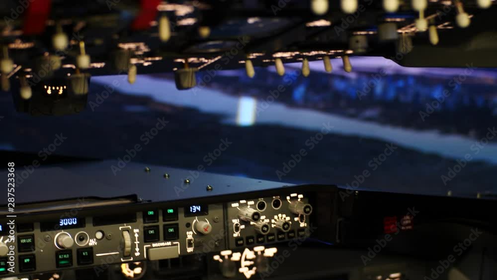 Cockpit of a passenger plane in flight at dusk