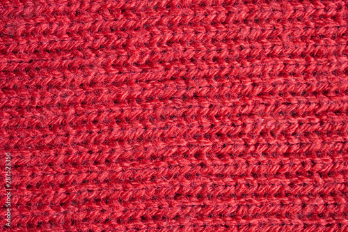 Red knitted wool fabric texture background