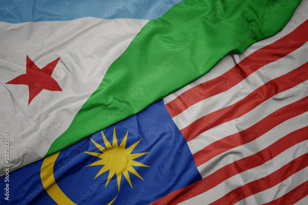 Fototapeta premium waving colorful flag of malaysia and national flag of djibouti.