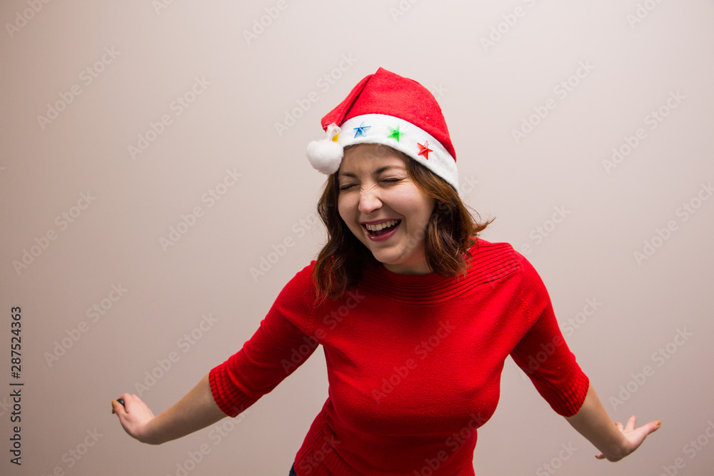 happy girl in santa hat in red blouse on white background happy girl in santa hat in red blouse on white background