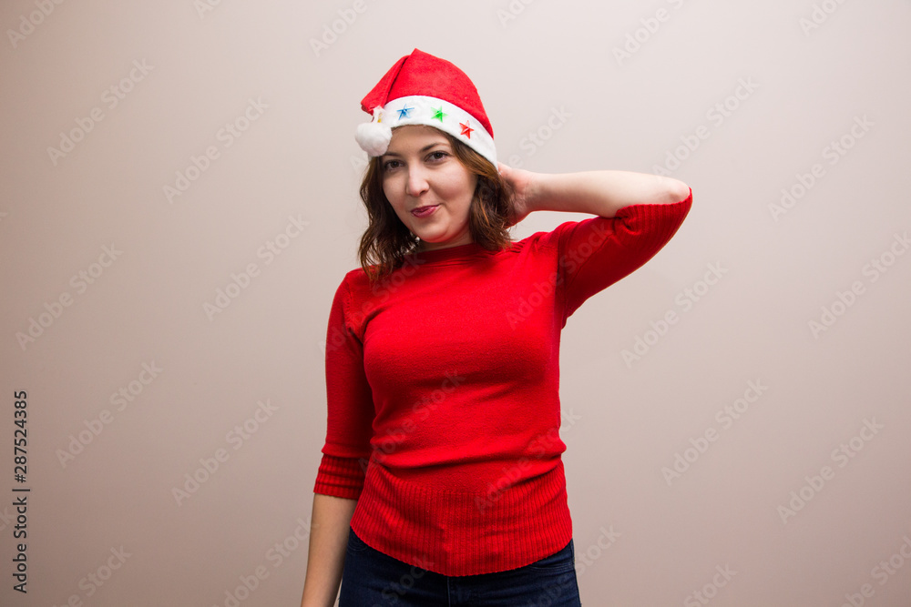 happy girl in santa hat in red blouse on white background 