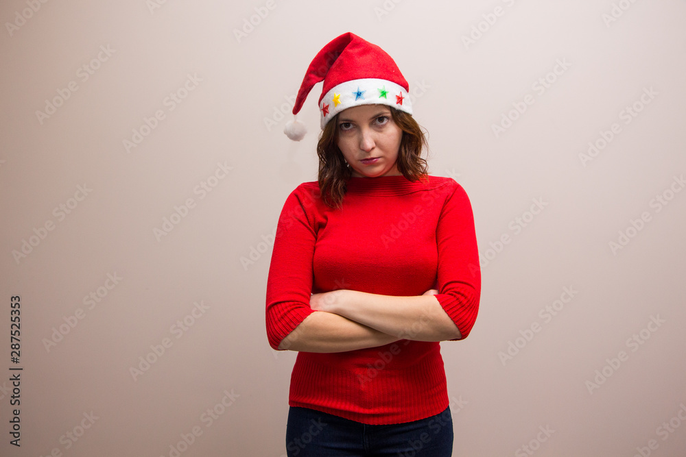 happy girl in santa hat in red blouse on white background happy girl in santa hat in red blouse on white background
