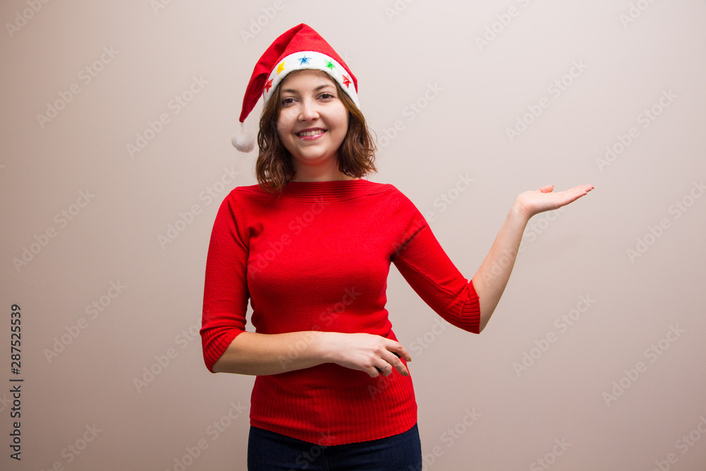 happy girl in santa hat in red blouse on white background happy girl in santa hat in red blouse on white background