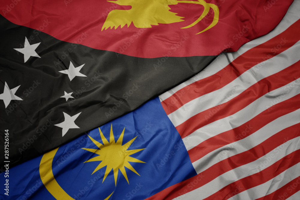 waving colorful flag of malaysia and national flag of Papua New Guinea . waving colorful flag of malaysia and national flag of Papua New Guinea .