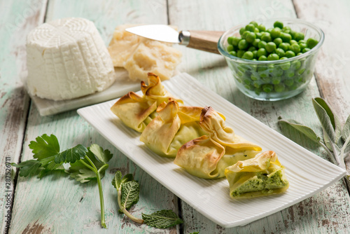 fagottini filled with ricotta parmesan cheese and green peas photo